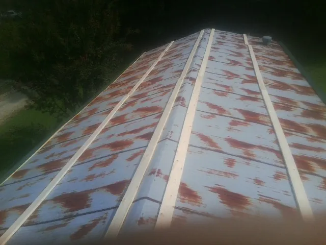 Rusted metal roof panels with new wood purlins before replacement — Storm Damage Roof Repair in Castaic by Roofing Brothers