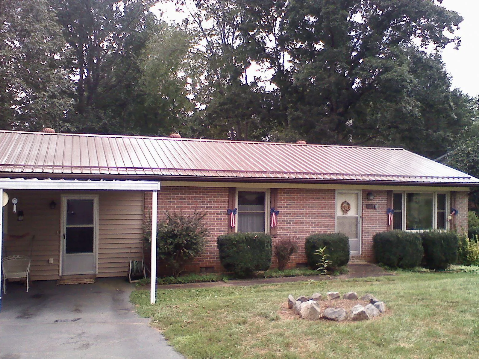 Bronze metal roof and carport on a brick ranch home — Roof Repair work by our crew in Castaic